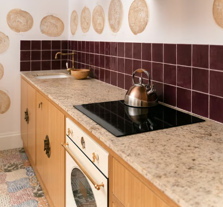 Brown kitchen splashback with kettle on the stove
